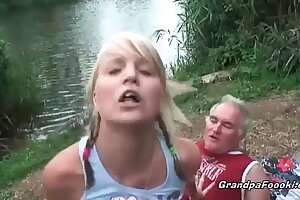 Gorgeous blonde rides dick on the river shore